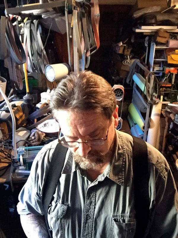 Patron Saint of Knives at work in his sharpening studio